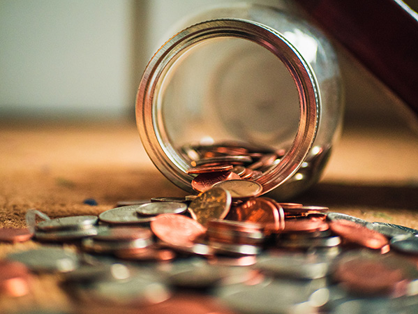 coins-on-wood-floor-from-jar