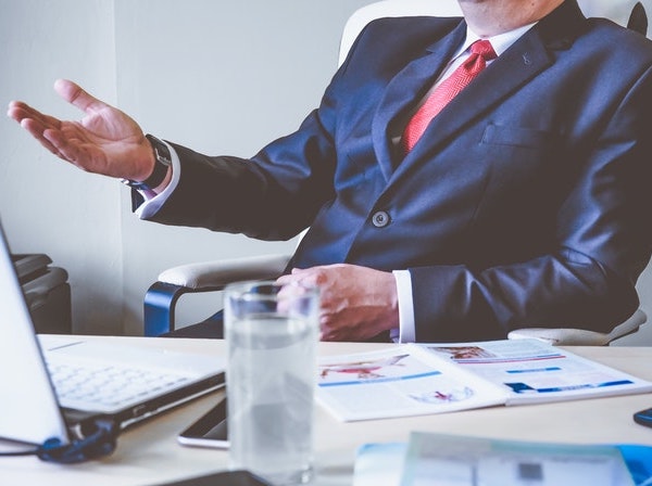 solicitor-sat-at-desk-speaking-to-client